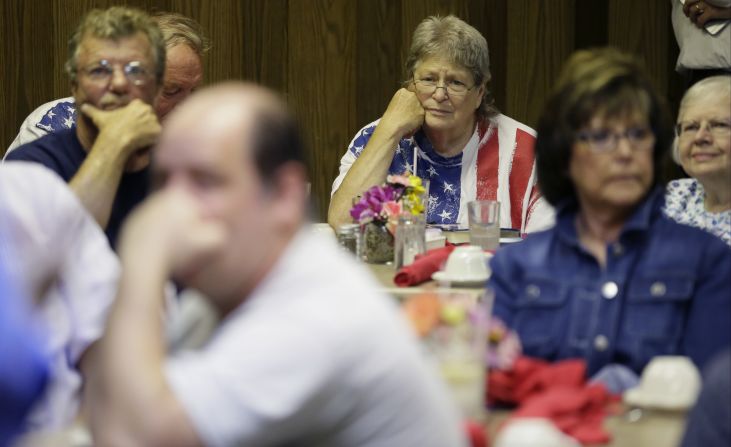 Honey Davis, of Onawa, Iowa, center, listens as Republican presidential candidate Louisiana Gov. Bobby Jindal speaks during a meet and greet with residents on Wednesday, September 2, in Denison, Iowa.