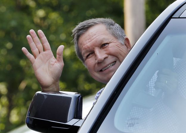 Republican presidential candidate Gov. John Kasich waves as he arrives for a campaign stop at Robie's Country Store on Wednesday, September 2, in Hooksett, New Hampshire. 