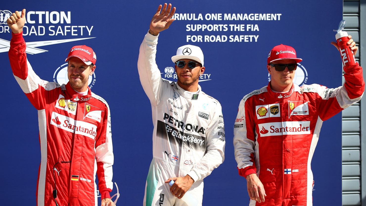 Lewis Hamilton (center) celebrates next to Sebastian Vettel (L)  Kimi Raikkonen after claiming pole position during qualifying for the Formula One Grand Prix of Italy.