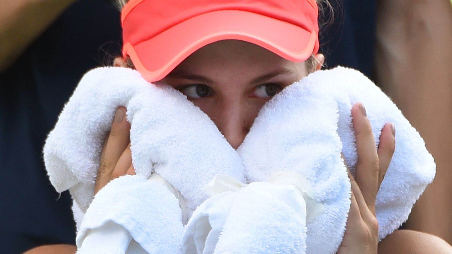 Eugenie Bouchard holds a towel to her face at the U.S. Open women's singles match on September 4, 2015 in New York. 