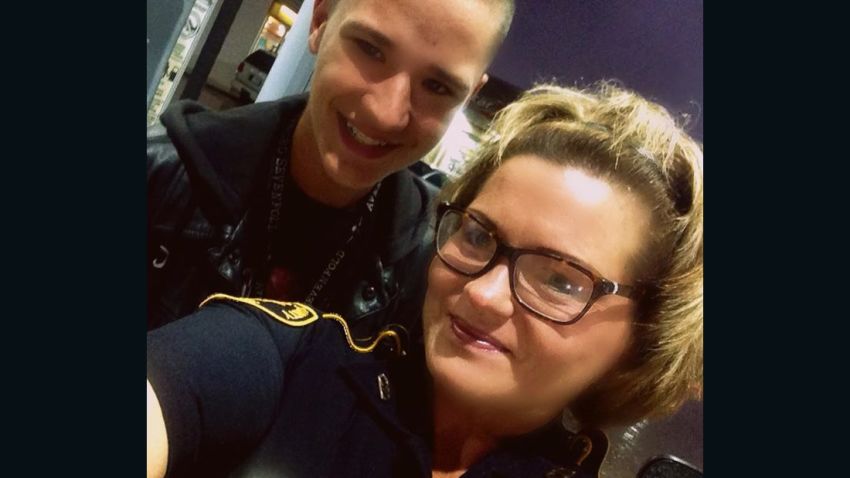 In this Facebook photo, Texas teenager provides "backup" for Harris County Deputy Constable Tommi Jones Kelley while she's refueling her patrol car near Houston. 