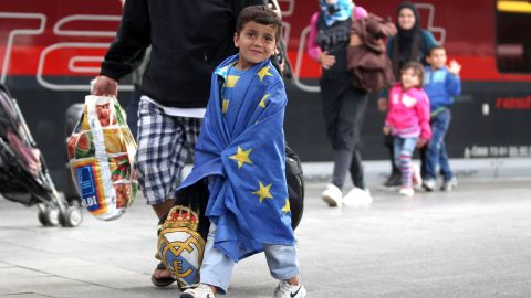 A migrant boy wrapped in an EU flag arrives from Austria to Munich, Germany,  on September 5, 2015 