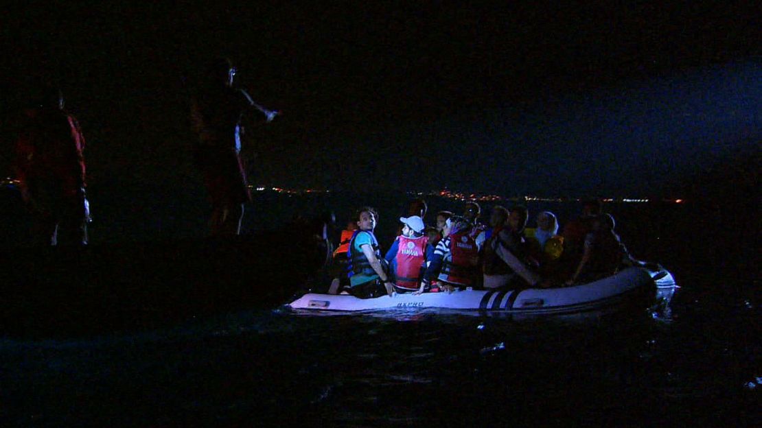 Volunteers from Bodrum Sea Rescue Association -- which works alongside the Turkish Coast Guard -- instruct stranded migrants prior to pulling them aboard their boat.