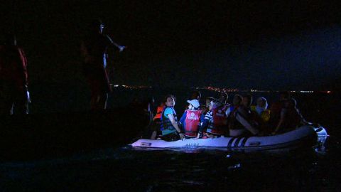 Volunteers from Bodrum Sea Rescue Association -- which works alongside the Turkish Coast Guard -- instruct stranded migrants prior to pulling them aboard their boat.