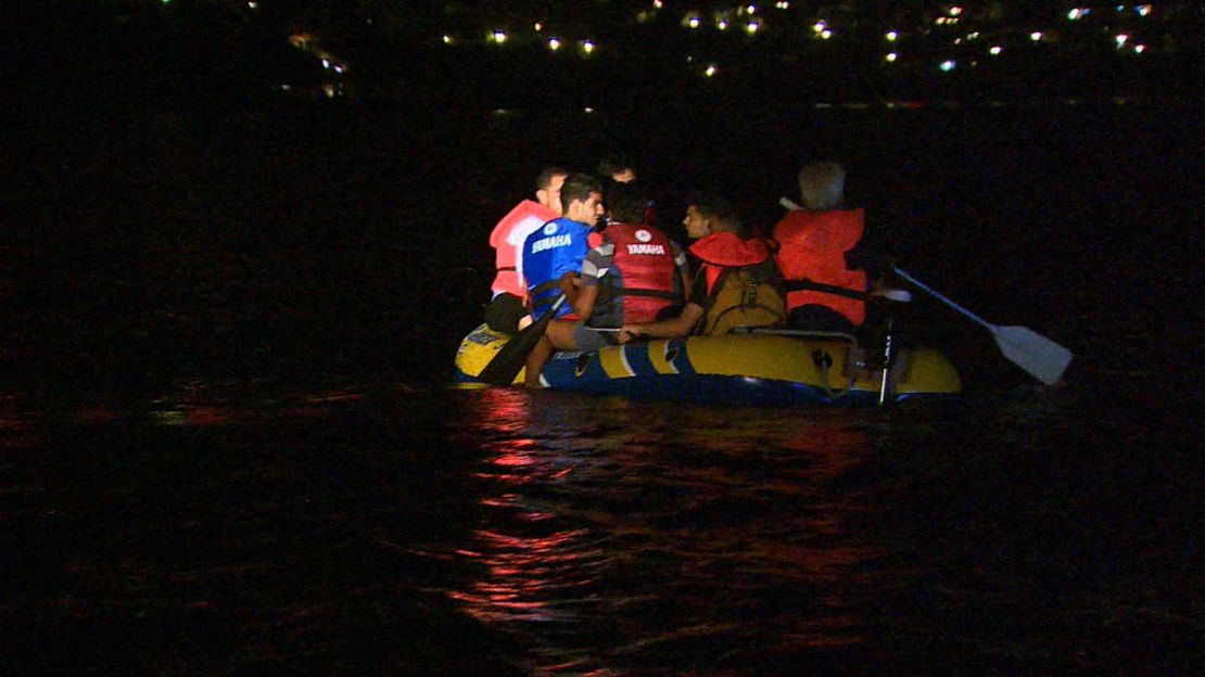 Migrants crowd an inflatable boat which they're trying to row from Turkey to Greece.