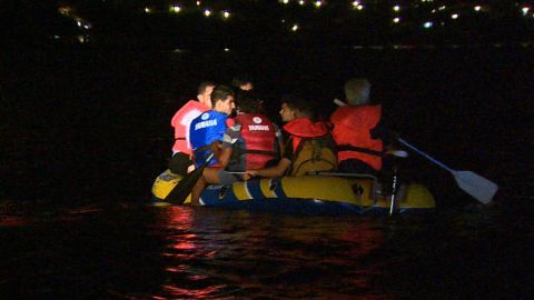 Migrants crowd an inflatable boat which they're trying to row from Turkey to Greece.