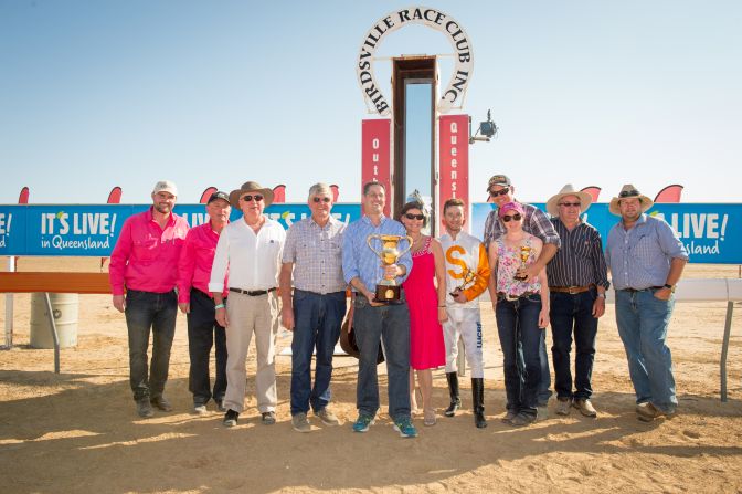 Iron Meteorite trainer Jay Morris proudly shows off the Birdsville Cup following the award ceremony.  <br /><br />Sharon Chapman will be presenting an exhibition of her Birdsville photos alongside equine artist, Janet Hammill in 2016. You can view more of her work at <a href="index.php?page=&url=http%3A%2F%2Fwww.fasttrackphotography.com.au" target="_blank" target="_blank">http://www.fasttrackphotography.com.au</a> and follow her on Twitter <a href="index.php?page=&url=https%3A%2F%2Ftwitter.com%2FFastTrackPhotog" target="_blank" target="_blank">@FastTrackPhotog</a>