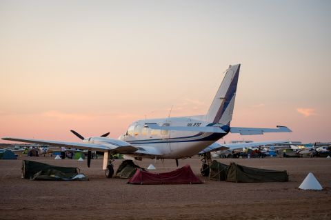 The local airstrip, which lies largely empty for most of the year becomes an arrivals lounge and impromtu campsite rolled into one. <br /><br />"People fly by light plane," explains Jo McKinnon from the Birdsville Race Club. "The airstrip is right alongside the pub. Some people even camp under the wings of their plane or sleep in them."