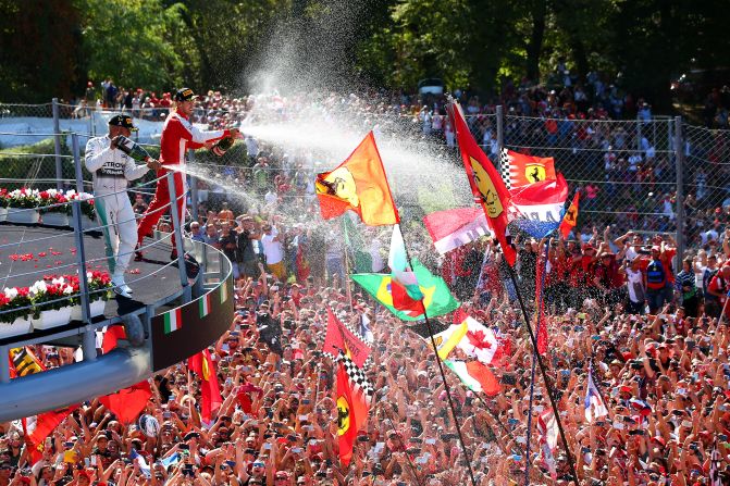 Hamilton sprays the crowd with champagne after securing his seventh victory of the season that extended his lead in the drivers' championship to 53 points.