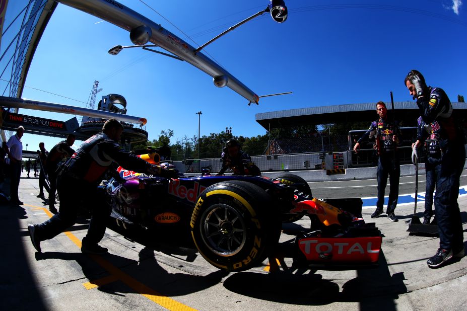 The car of Russian Red Bull driver Daniil Kvyat returns to the garage for a tune-up before the racing begins in earnest.
