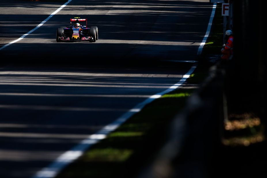 Carlos Sainz's Toro Rosso zips down one of the straights, splintered by sunlight through the trees.