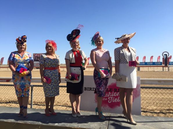 Ladies pose for a photo beside the Birdsville racetrack -- a welcome splash of color amid a sea of scrub and dirt.