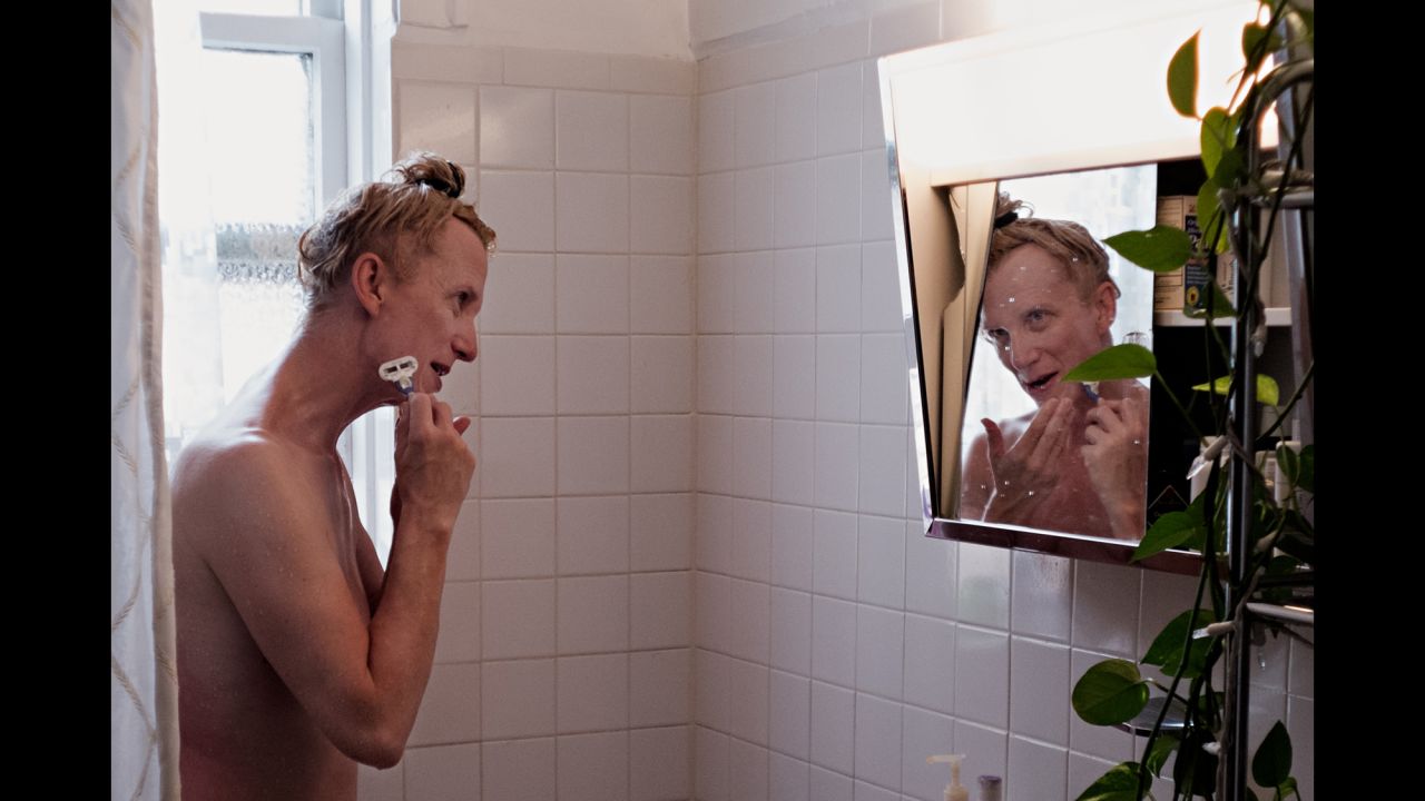The hormones and electrolysis have not completely freed Delia from all male routines,  such as shaving her face.