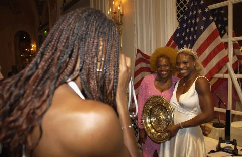 Venus snaps a photo of Serena and their mother at the Wimbledon Champions Dinner.