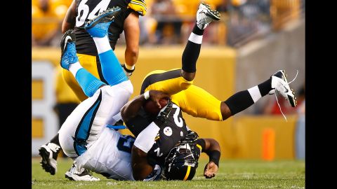 Pittsburgh quarterback Michael Vick is tackled by Carolina's Kawann Short during an NFL preseason game in Pittsburgh on Thursday, September 3.