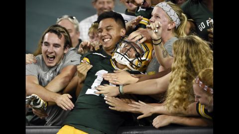 Green Bay Packers wide receiver Myles White is congratulated by fans after he scored a preseason touchdown on Thursday, September 3.