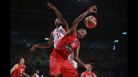 Miguel Ruiz of Venezuela, left, competes against Puerto Rico's Renaldo Balkman during a preliminary-round game at the FIBA Americas Championship on Wednesday, September 2.