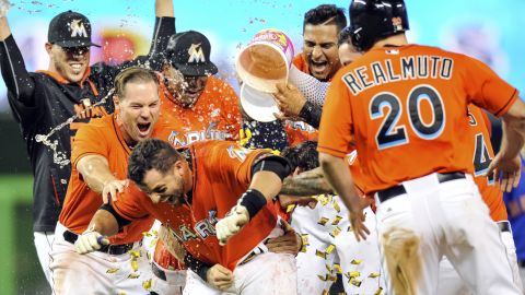 Miami's Martin Prado is showered with water and bubble gum after his sacrifice fly defeated the New York Mets on Sunday, September 6.