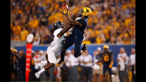 West Virginia's Tyrek Cole catches a pass in front of Georgia Southern's Deshawntee Gallon during a college football game played Saturday, September 5, in Morgantown, West Virginia.