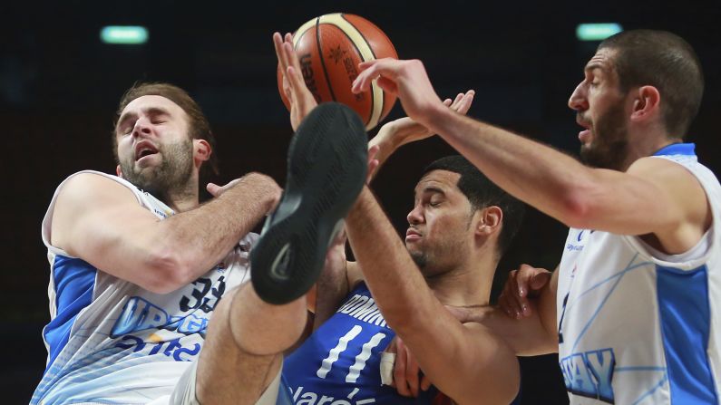 Eloy Vargas, a basketball player for the Dominican Republic, collides with Uruguay's Kiril Wachsmann, left, during a preliminary-round game at the FIBA Americas Championship on Thursday, September 3.