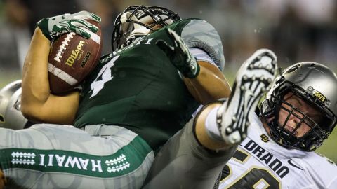 Hawaii running back Steven Lakalaka is stopped by Colorado's Jase Franke during a college football game in Honolulu on Thursday, September 3.