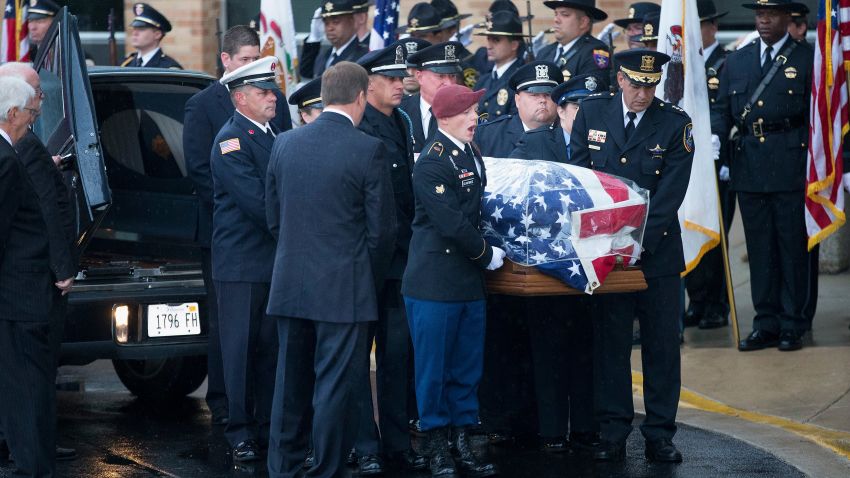 ANTIOCH, IL - SEPTEMBER 07: With his son (maroon beret) calling commands, the coffin of slain Fox Lake police officer Lt. Joe Gliniewicz is carried into Antioch Community High School for his visitation and funeral service on September 7, 2015 in Fox Lake, Illinois.  Gliniewicz was shot and killed on September 1, while on duty in Fox Lake. Police are searching for three suspects in connection with his death.  (Photo by Scott Olson/Getty Images)