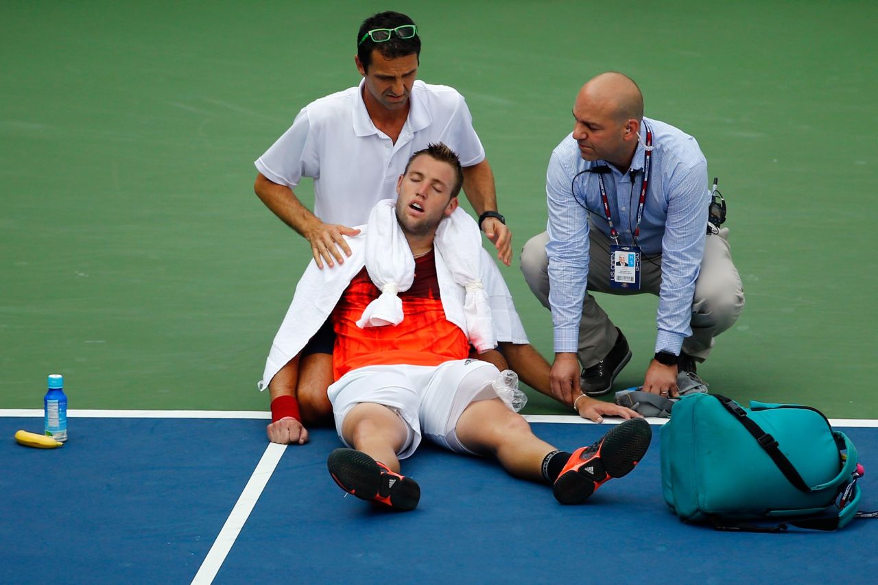 Temperatures over the past week at the U.S. Open have consistently touched above 90F (32C). Here Jack Sock of the U.S. receives assistance from trainer Hugo Gravil for heat exhaustion before withdrawing from his second round match against Ruben Bemelmans of Belgium.
