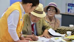 An elderly South Korean man (C) who left behind relatives in North Korea fills out applications for an expected inter-Korean family reunion programme at the Red Cross office in Seoul on September 7, 2015. North and South Korean Red Cross officials kicked off talks on September 7 on organising a rare and emotional reunion for families separated by the Korean War.  AFP PHOTO / JUNG YEON-JE        (Photo credit should read JUNG YEON-JE/AFP/Getty Images)