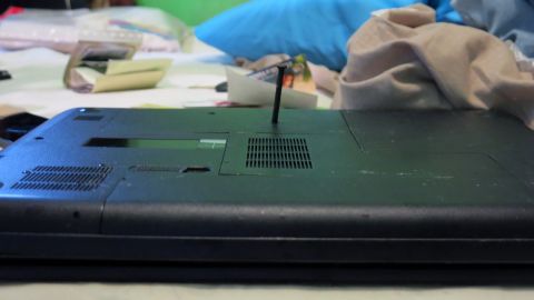 When authorities knocked on the door, the suspect drove a nail through his laptop, piercing the hard drive, authorities said. He also began chewing pieces of paper containing Americans' names and numbers.