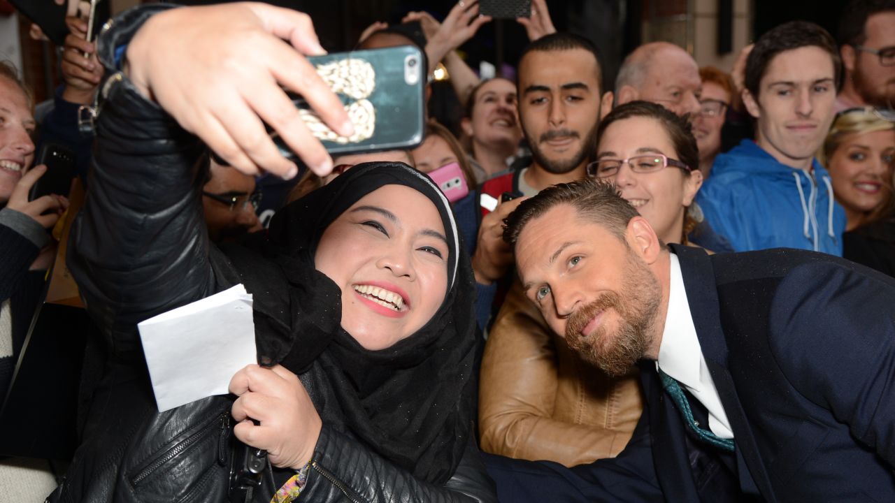 Actor Tom Hardy leans in for a fan's selfie at the London premiere of "Legend" on Thursday, September 3.