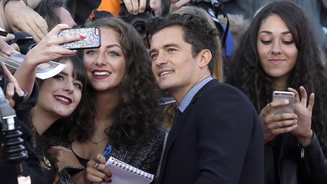 Fans in Deauville, France, take photos with actor Orlando Bloom at the Deauville American Film Festival on Sunday, September 6.