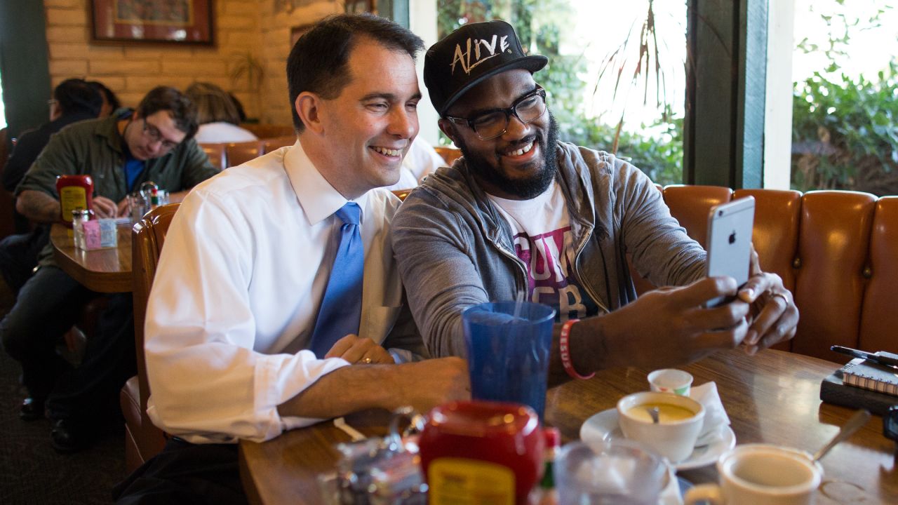 Wisconsin Gov. Scott Walker, a Republican presidential candidate, poses for a selfie during a campaign stop in Midland, Texas, on Friday, September 4.