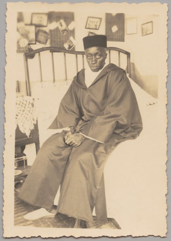 This unknown but nonetheless prolific amateur photographer appears to have captured a series of shots of his friends and family, often in their own homes.<br /><br />Seated Man, 1930s-1940s<br />Unknown Artist (Senegal)<br />Gelatin silver print