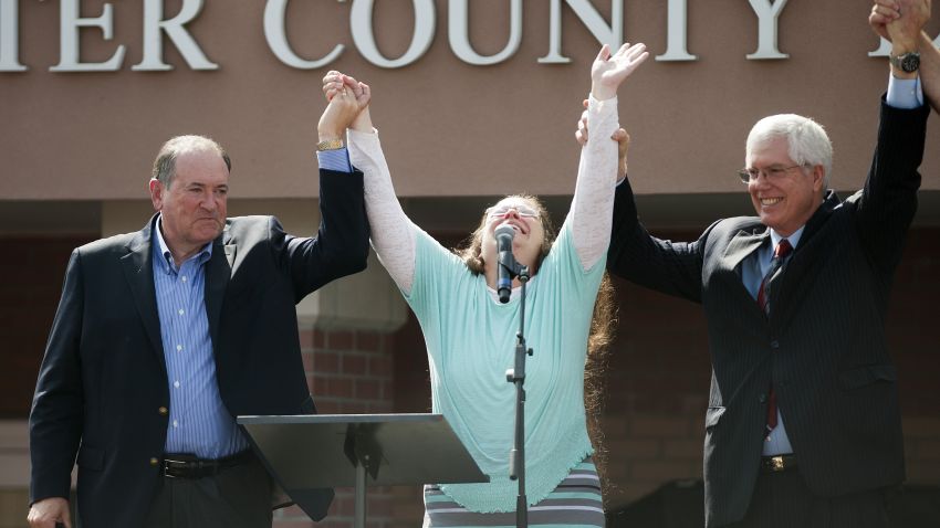 Rowan County Clerk of Courts Kim Davis holds her hands in the air with her attorney Mat Staver and Republican presidential candidate Mike Huckabee in front of the Carter County Detention Center on September 8, 2015 in Grayson, Kentucky.