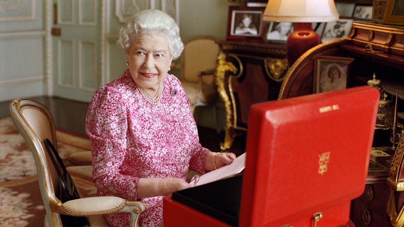 The Queen sits at a desk in Buckingham Palace in July 2015.