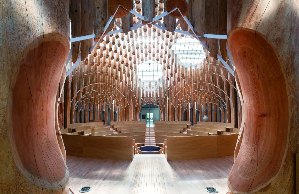 The church's interior takes note of its mountainous and heavily forested surroundings -- its interior looks like an inverted treehouse, made of 834 differently sized pieces of Siberian red cedar wood. A cross is fixed in the middle of a pool of water. 
