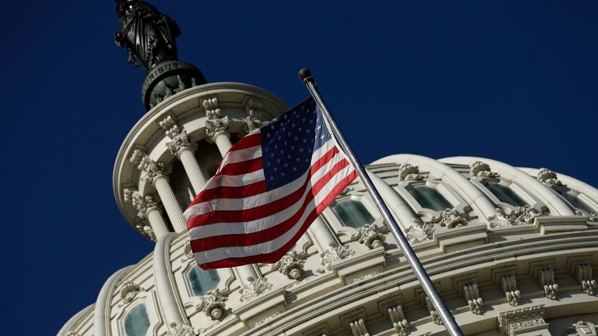 WASHINGTON, DC - SEPTEMBER 29: An American flag waves outside the United States Capitol building as Congress remains gridlocked over legislation to continue funding the federal government September 29, 2013 in Washington, DC. The House of Representatives passed a continuing resolution with language to defund U.S. President Barack Obama's national health care plan yesterday, but Senate Majority Leader Harry Reid has indicated the U.S. Senate will not consider the legislation as passed by the House. (Photo by Win McNamee/Getty Images)
