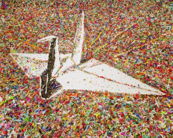 This photo was created by Brazilian visual artist and photographer Vik Muniz. He is known for making drawings out of unusual materials, which in the past have included chocolate syrup, diamonds and garbage. Muniz created this image by assembling hundreds of thousands of paper cranes made by children around the world to commemorate the victims of the 2011 Japanese Earthquake and Tsunami. <br />