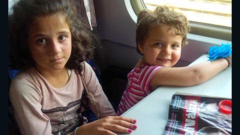 Rym, 8, and Birlnt, 2 1/2, on the train as it starts to move.