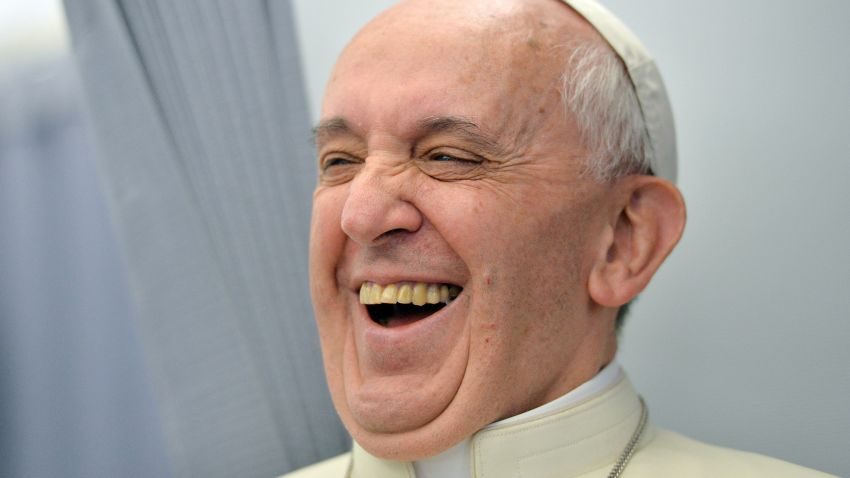 Pope Francis laughs while addressing journalists of the papal flight, upon arrival in Rio de Janeiro on July 22, 2013. Pope Francis landed in Brazil on Monday for his first overseas trip as pontiff to attend the international festival World Youth Day in Brazil, the world's biggest Catholic country.    AFP PHOTO/LUCA ZENNARO/POOL        (Photo credit should read LUCA ZENNARO/AFP/Getty Images)