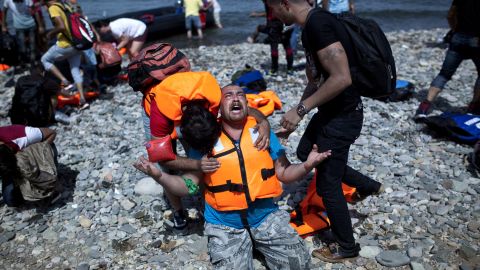 A refugee from Syria prays after arriving on the shores of the Greek island of Lesbos aboard an inflatable dinghy across the Aegean Sea from from Turkey on September 7, 2015. Greece sent troops and police reinforcements on September 6 to Lesbos after renewed clashes between police and migrants, the public broadcaster said, while Syrian refugees on the island were targeted with Molotov cocktail attacks. More than 230,000 people have landed on Greek shores this year and the numbers have soared in recent weeks as people seek to take advantage of the calm summer weather. AFP PHOTO / ANGELOS TZORTZINIS (Photo credit should read ANGELOS TZORTZINIS/AFP/Getty Images)