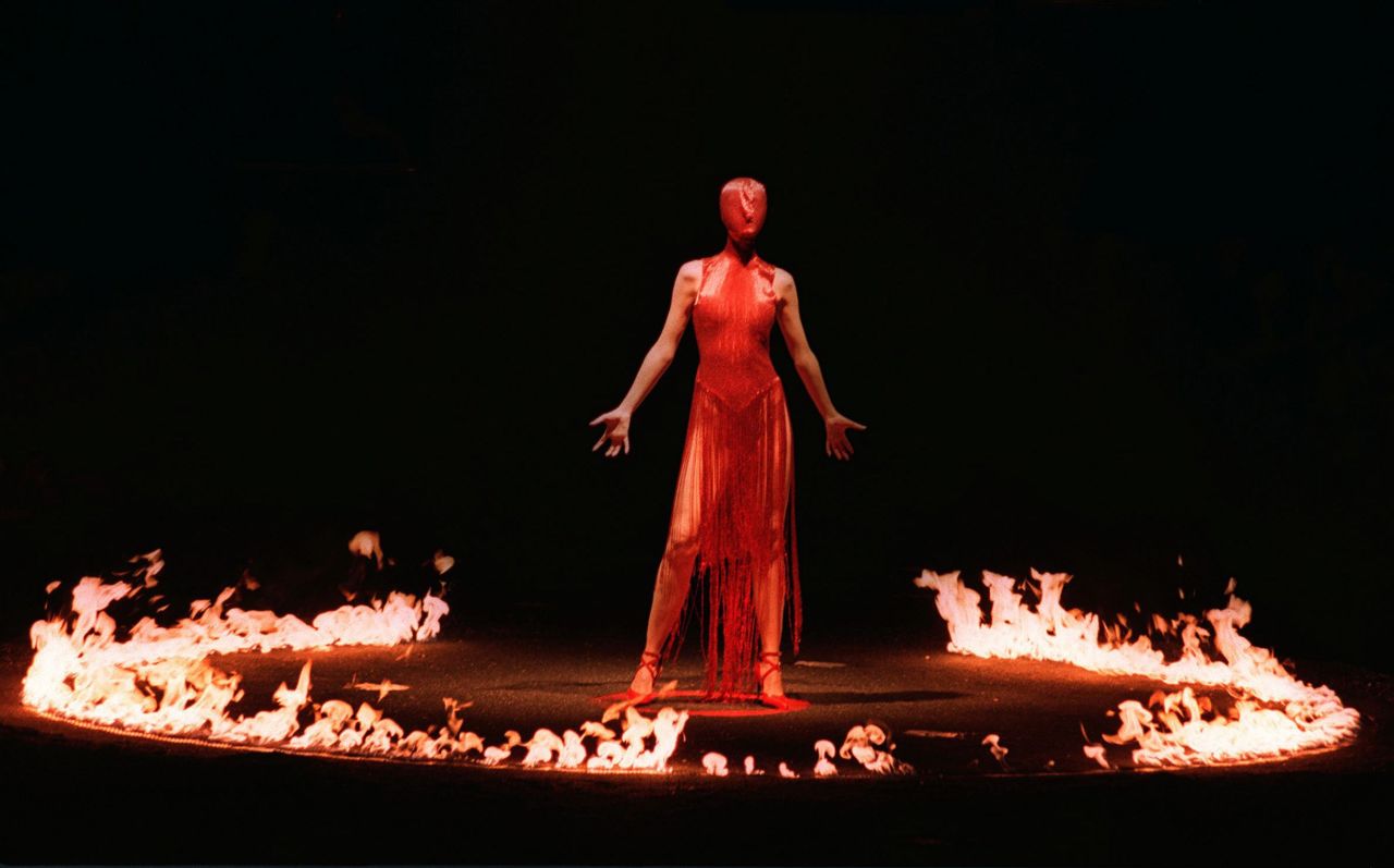 As a theatrical finale for his fall/winter show in 1998, Alexander McQueen sent a masked model down a dimly lit runway. Once she walked to the center of the stage, a ring of fire was lit around her. 