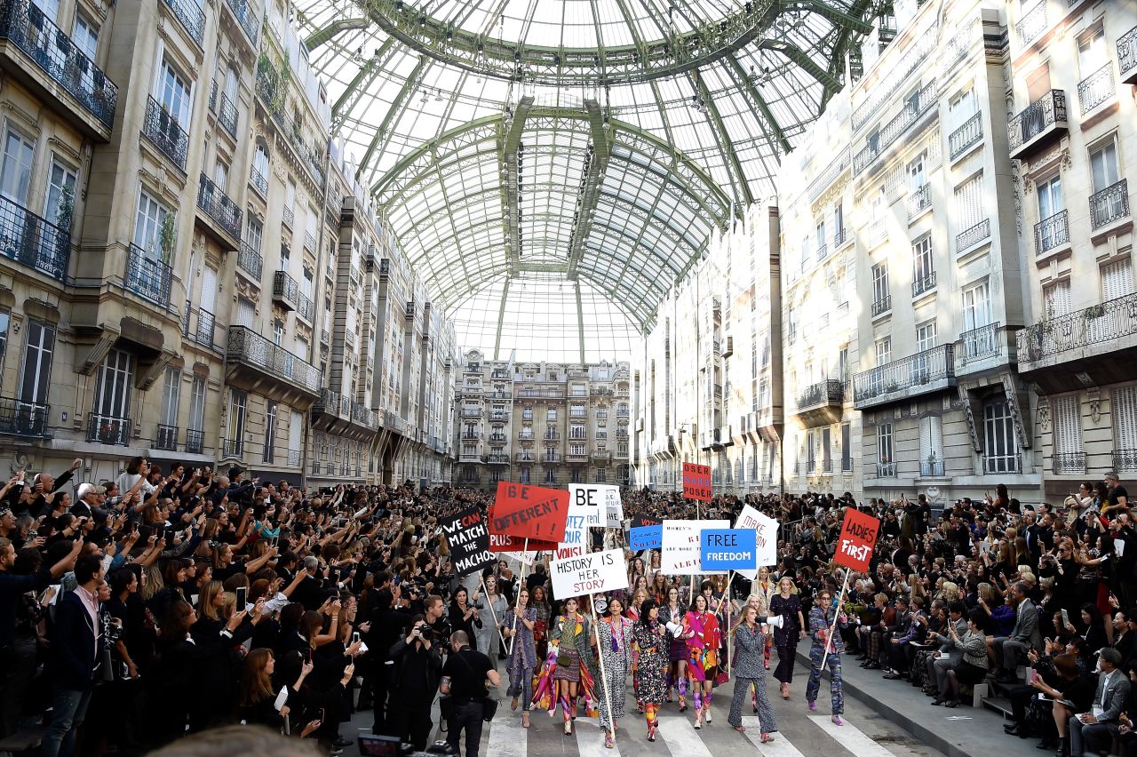 Chanel's spring/summer 2015 show converted the Grand Palais into a Parisian Boulevard, complete with small townhouses. As part of the show, the fashion house staged a street protest. 