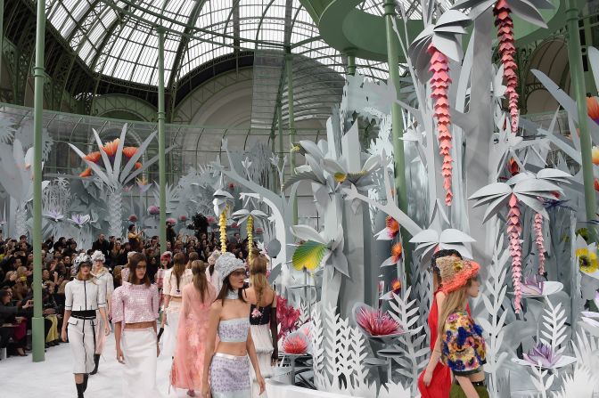 This extravagant set, conceived by Karl Lagerfeld, was a floral exhibit composed of blooming origami paper flowers. The fake flowers blossomed from bud to full bloom, during the show. 