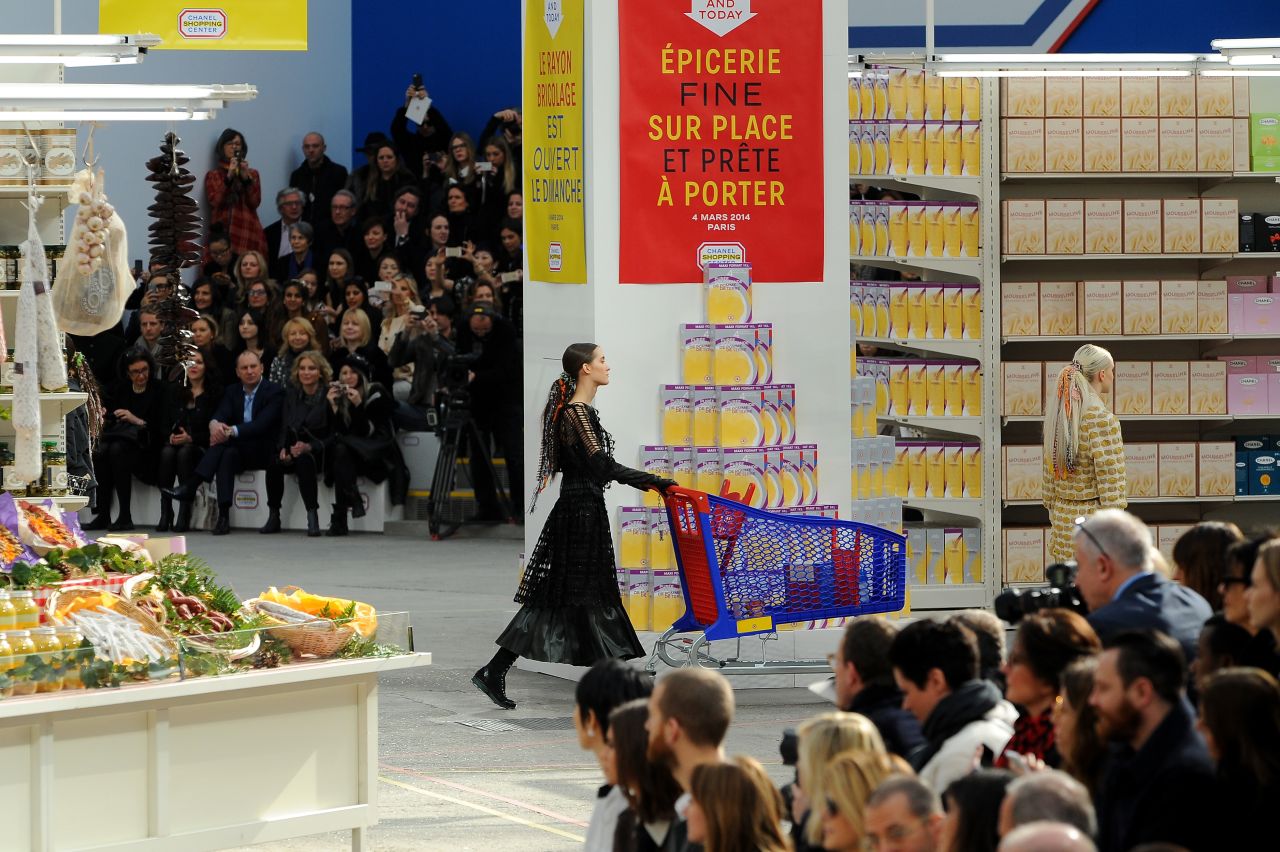 Models toted Chanel shopping bags and grocery carts, and proceeded to wind up and down the catwalk aisles while sifting through different Chanel-branded grocery items.