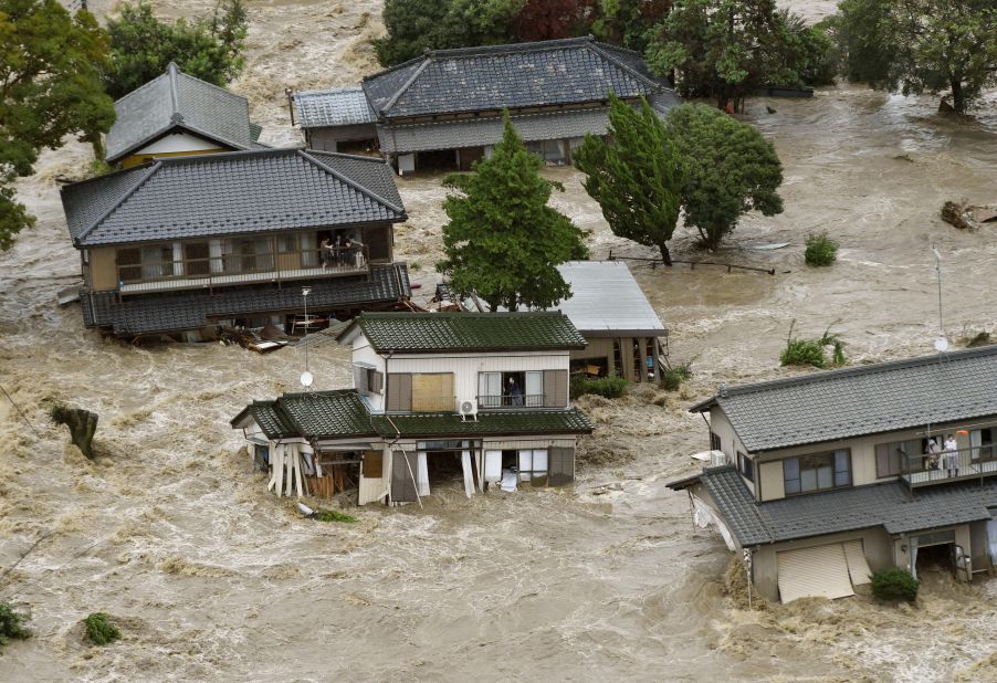 People wait to be rescued as houses are submerged in Joso on September 10.