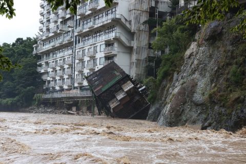 A hotel building plunges into floodwaters at a mountain resort in Nikko, Japan, on September 10.