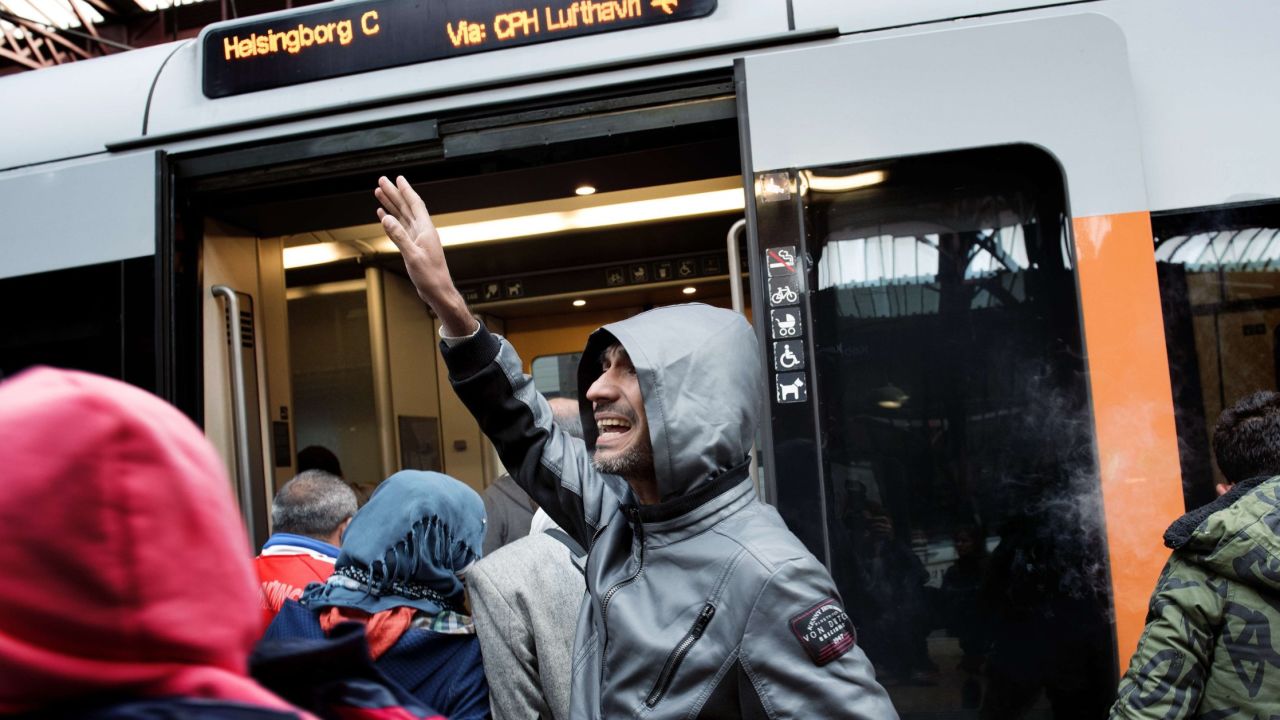 Migrants enter a train with direction to the Swedish town Helsingborg at the central railway station in Copenhagen on September 10, 2015. Denmark's train operator said Thursday it expected rail traffic across the German border to resume later in the day, after police ordered services to be suspended due to an influx of migrants. Police meanwhile announced they were letting refugees travel freely through Denmark without registering if they didn't want to seek asylum there, allowing them to head to Sweden which is the preferred destination of many because of its more welcoming and generous asylum policy.