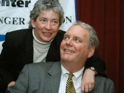 Lucinda Marker wraps her arm around her husband, John Tull, at Beth Israel Hospital in New York in February 2004.