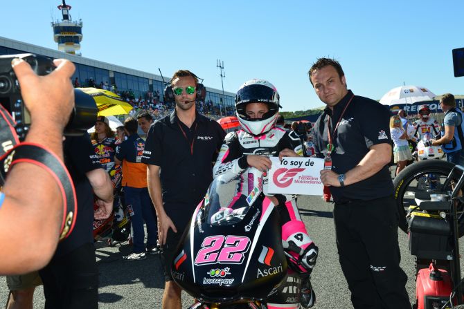 Carrasco holds a message before a race, supporting female motorcycling. She is the first female rider to score points in Moto3.